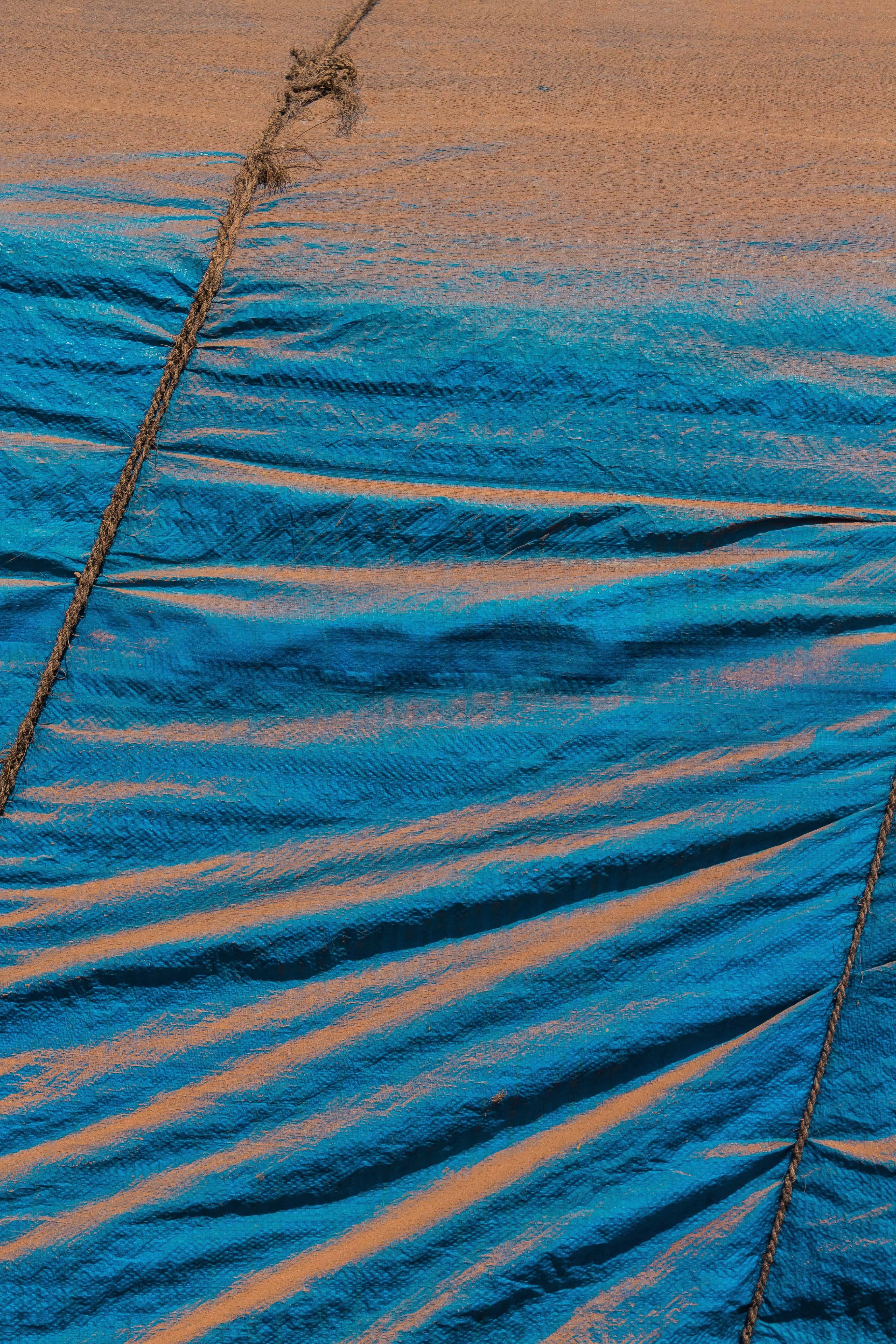 Shore — blue tarp and rope